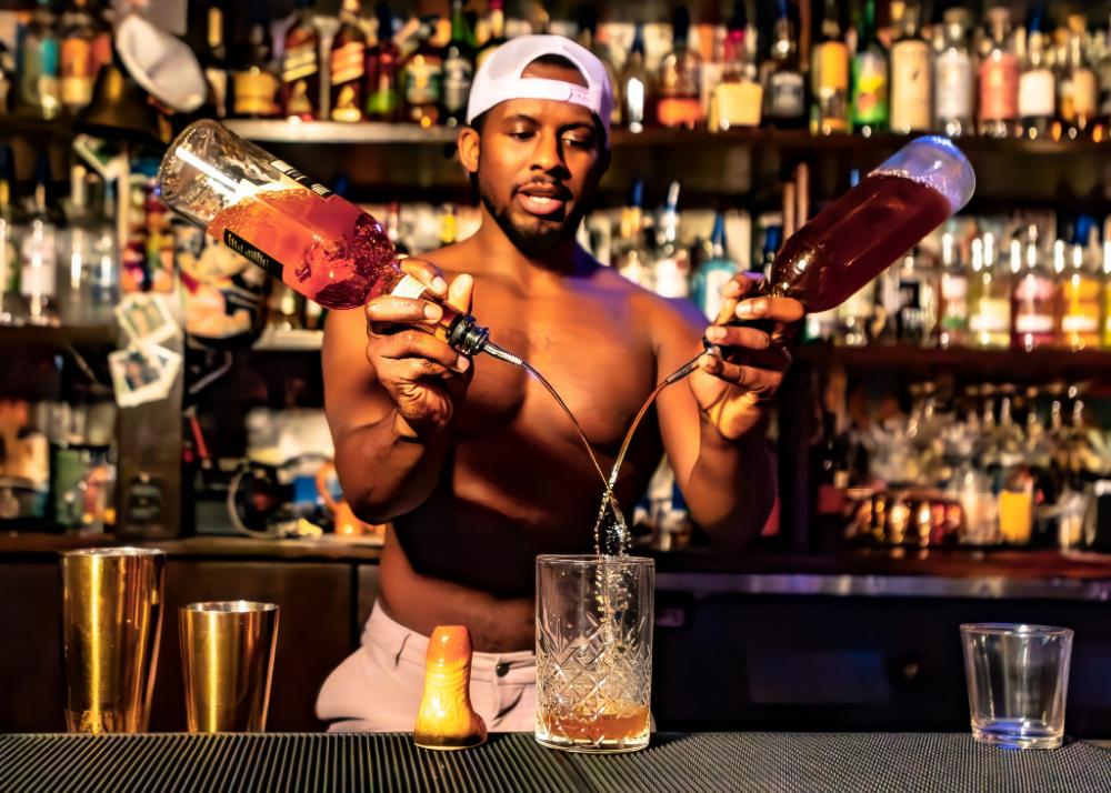 Bartender pouring cocktails at Schmittys WeHo nightlife bar